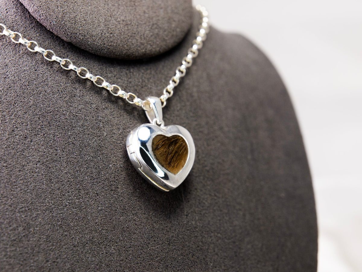 Pet hair memorial locket displayed on a jewellery bust