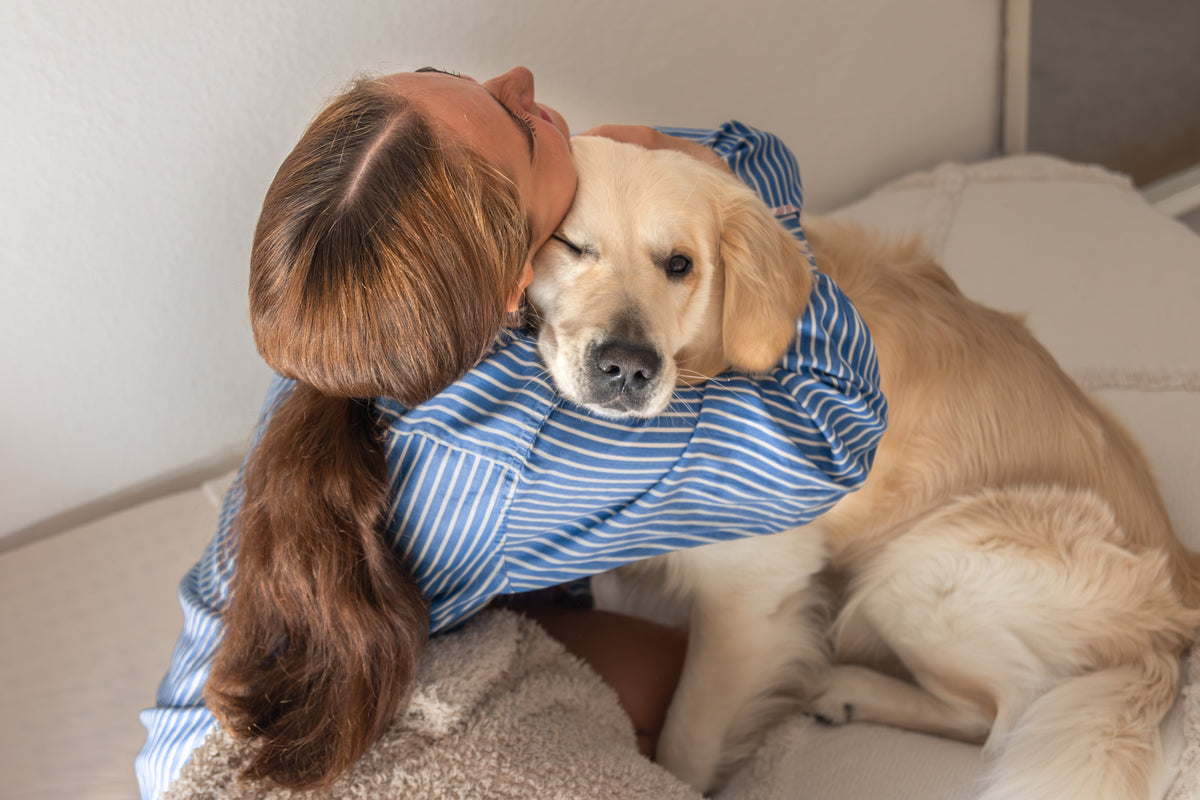 Teenager with dog at home for pet grief article