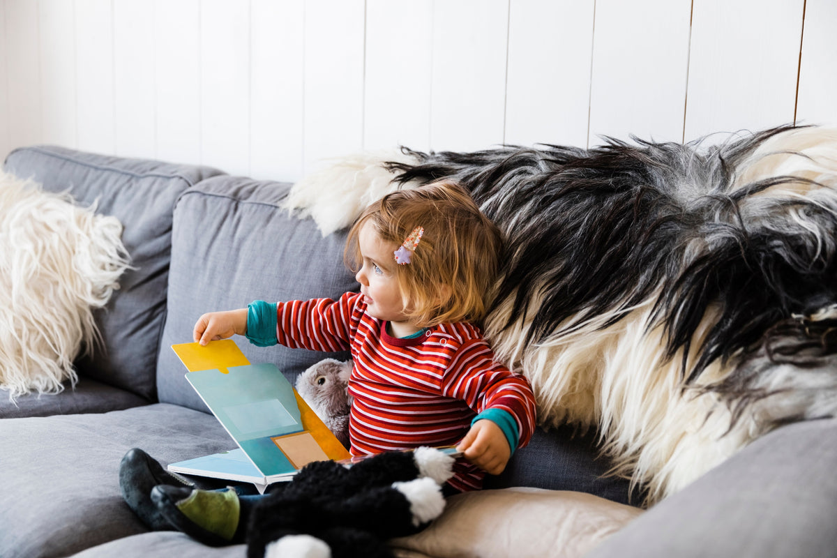 Woman and dog on a sofa for children’s pet loss book guide