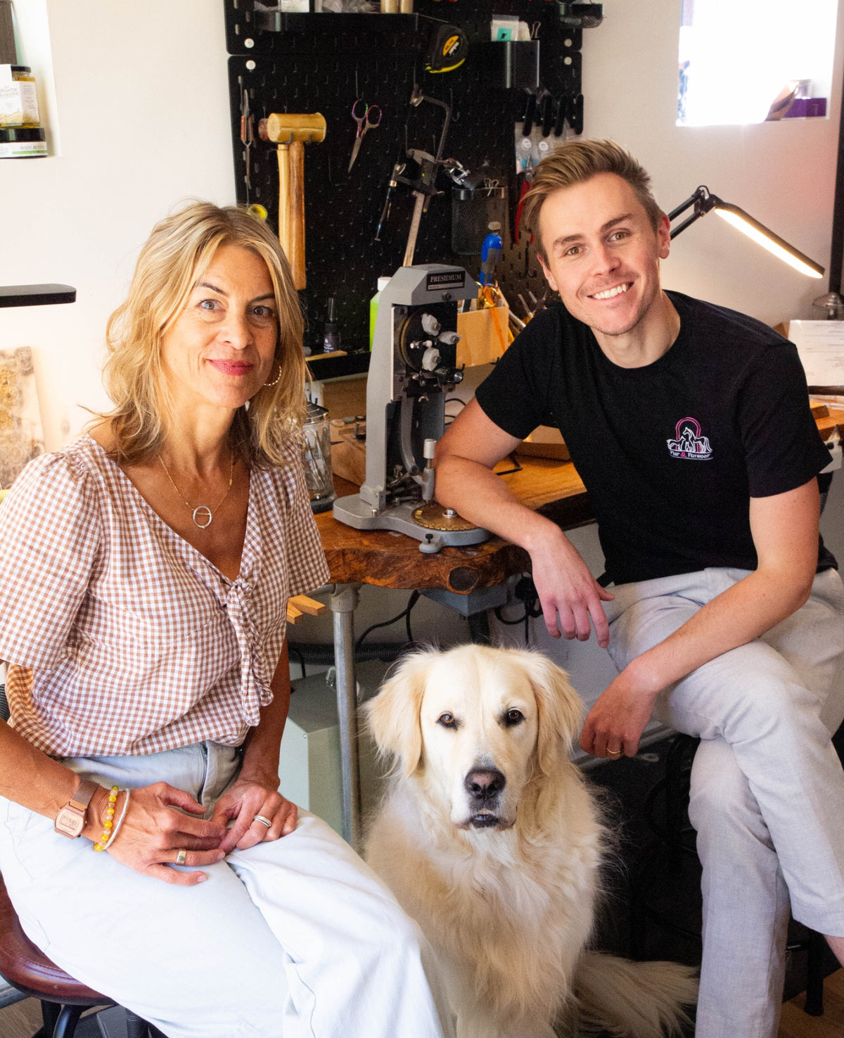 The Fur & Forever team with their golden retriever in the Brighton jewellery workshop.