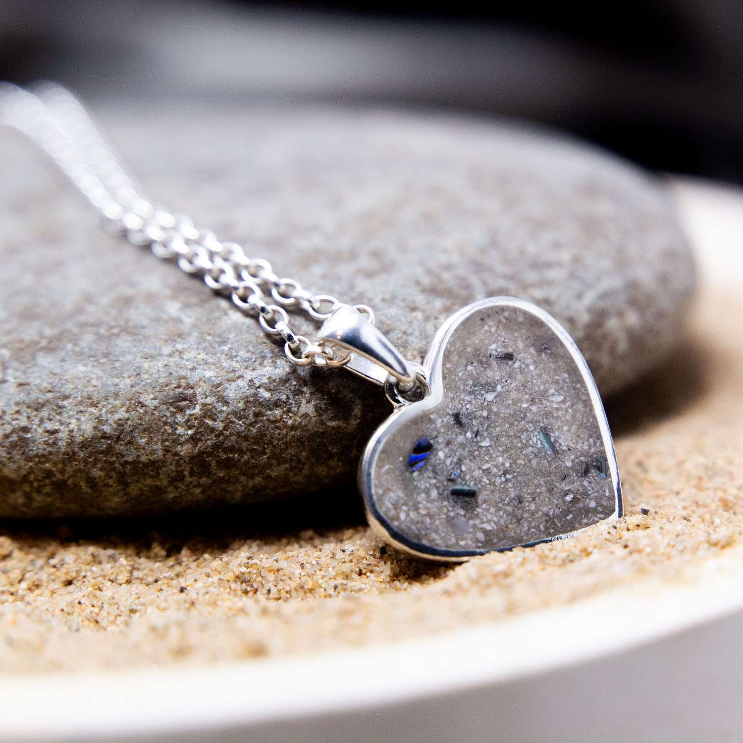 Cremation ashes preserved within a heart-shaped memorial necklace