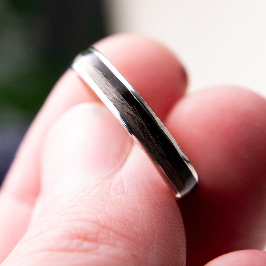 Close-up of fur strands set into the channel of a silver ring
