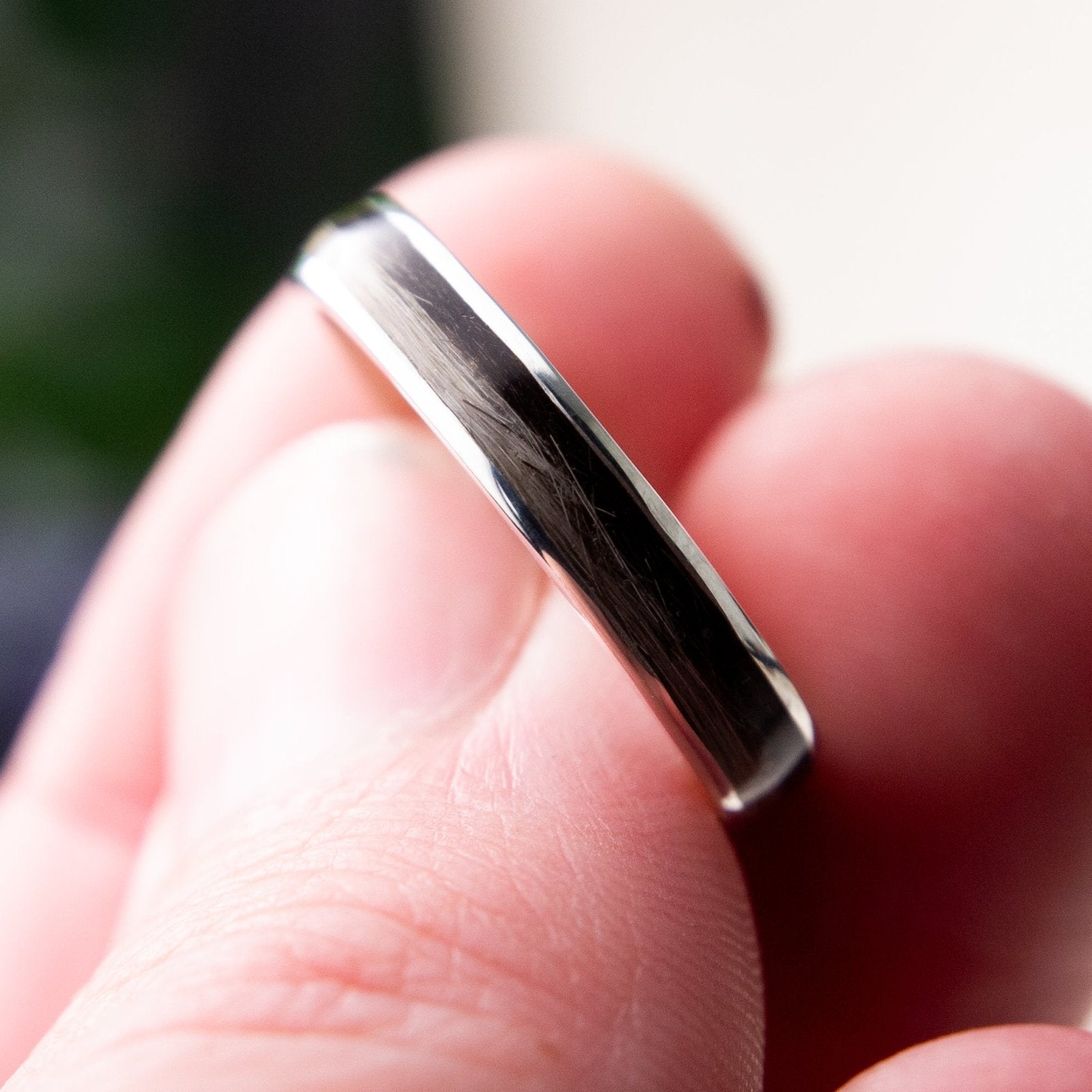Close up of a ring set with pet fur held between fingers